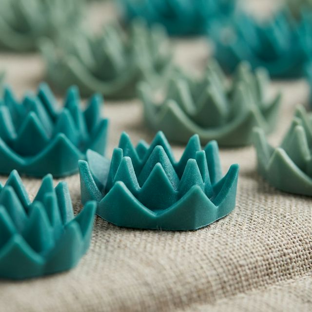 Close-up detail of acupressure spike clusters showing lotus-flower design