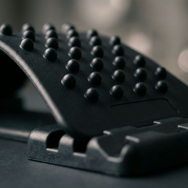 Close-up detail of adjustable height settings and acupressure nodule surface